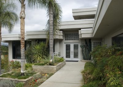 View to the front door of a linear looking home in the international contemporary style in Southern California