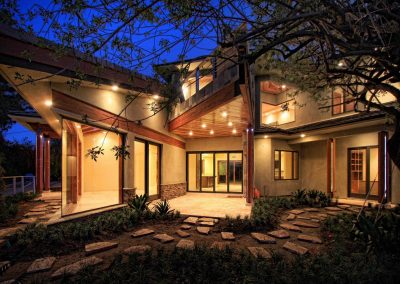 A contemporary home with wood and simulated stone and an angular, star shaped footprint