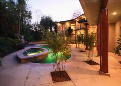 A vaguely Japanese inspired backyard of a strongly contemporary wood and stone home